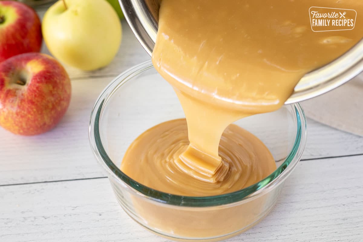 Pouring Caramel Apple Dip into glass container.