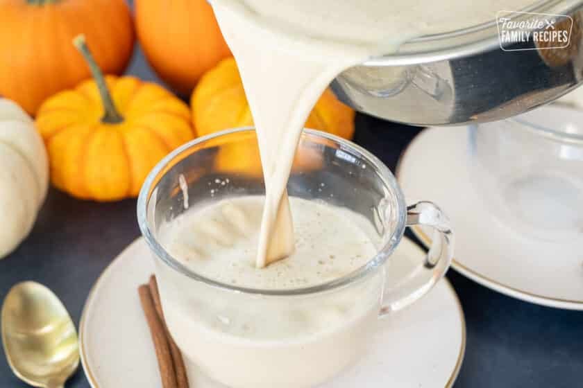 Pouring Pumpkin Spice Steamer in a mug.