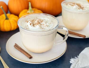 Pumpkin Spice Steamers in mugs with whipped cream.