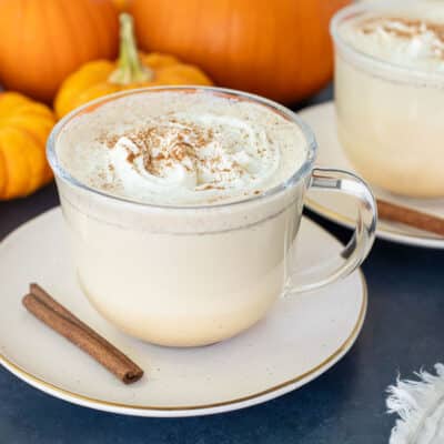 Pumpkin Spice Steamers in mugs with whipped cream.