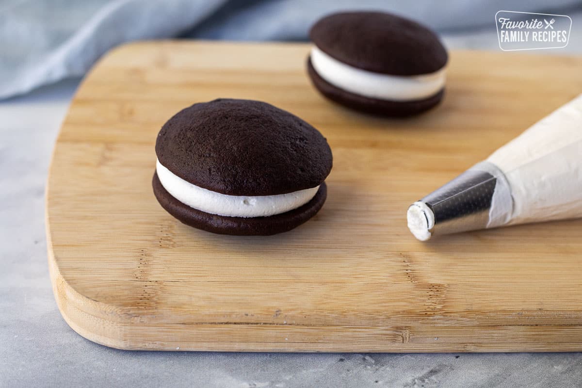 Sandwiched Whoopie Pie cookies next to piping bag.