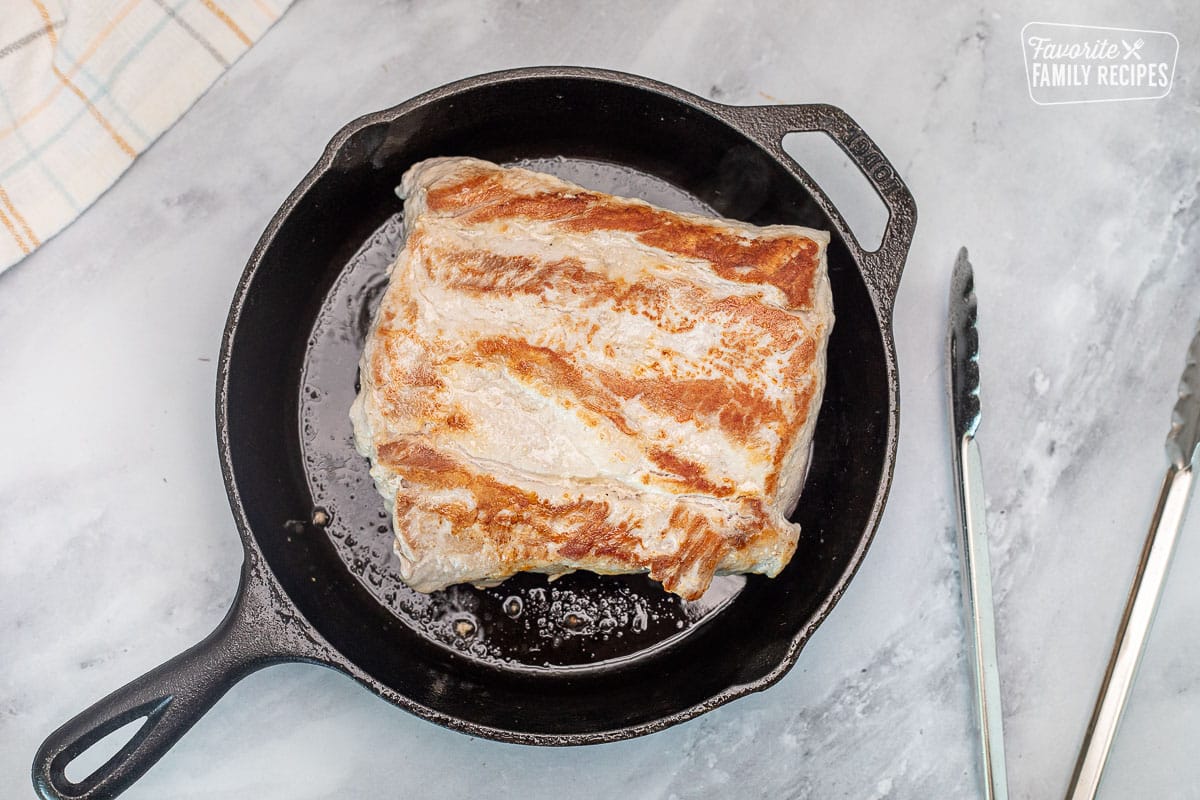 Searing a Pork Roast on a skillet with oil for Crock Pot.
