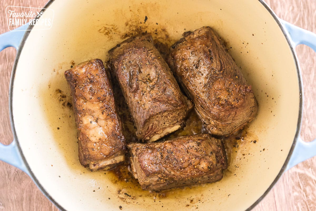 Seared short ribs in a large pot
