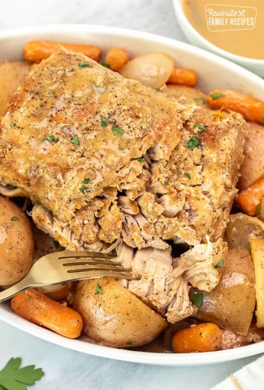 Fork pulling apart Crock Pot Pork Roast.