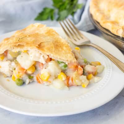 Slice of Homemade Chicken Pot Pie on a plate with a fork.