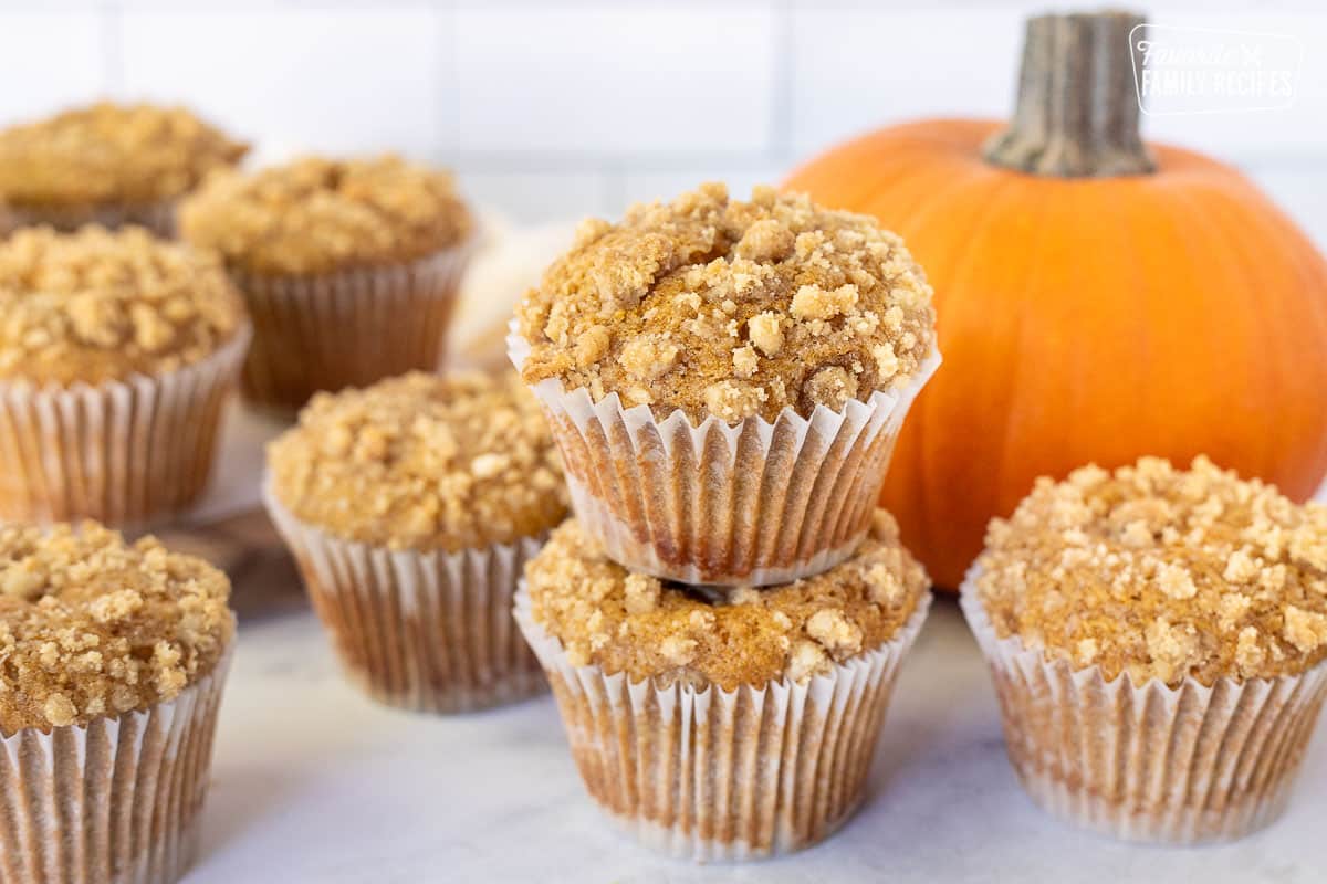 Multiple Pumpkin Cream Cheese Muffins and two stacked.