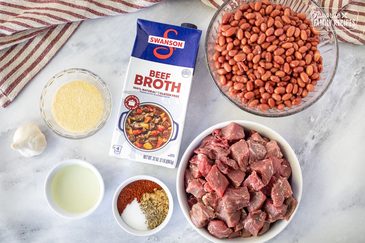 Ingredients to make Texas Chili including beef, spices, oil, cornmeal, garlic, beef broth and beans.
