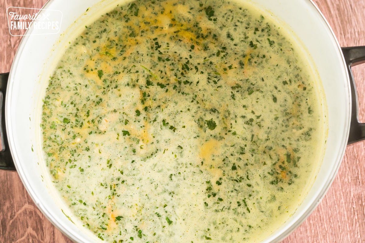 chicken broth and cilantro blended together in a large pot