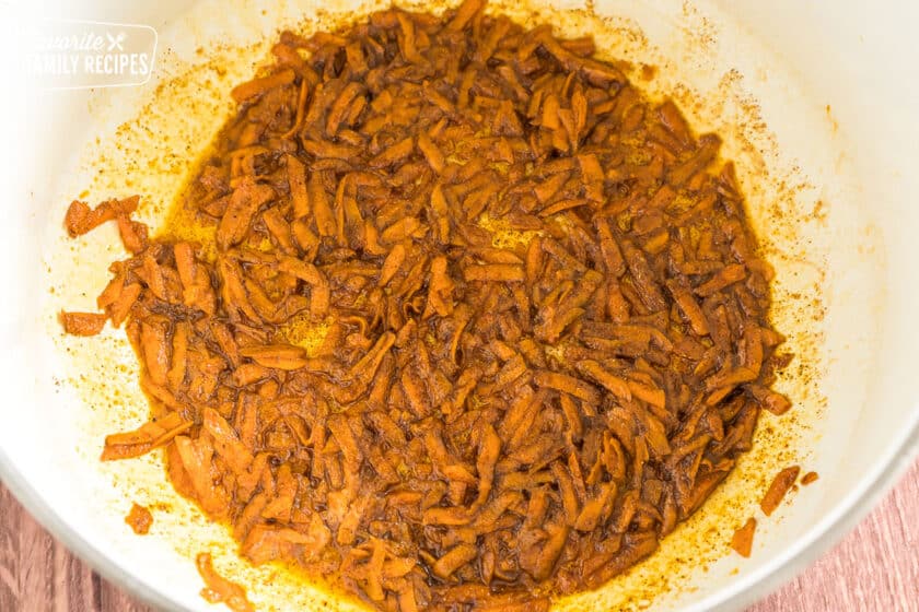 carrots cooking in thai spices in a large pot