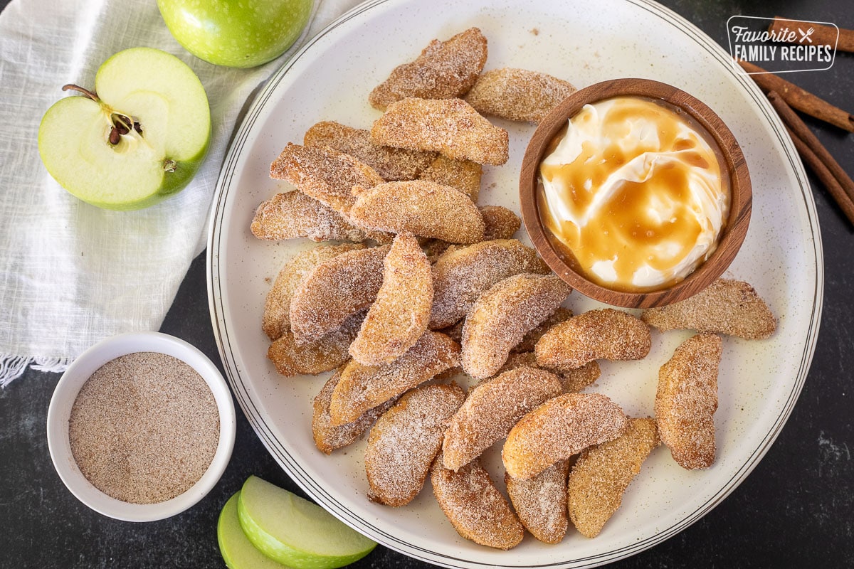 Apple Fries with cinnamon sugar next to a bowl of cream cheese caramel dip.