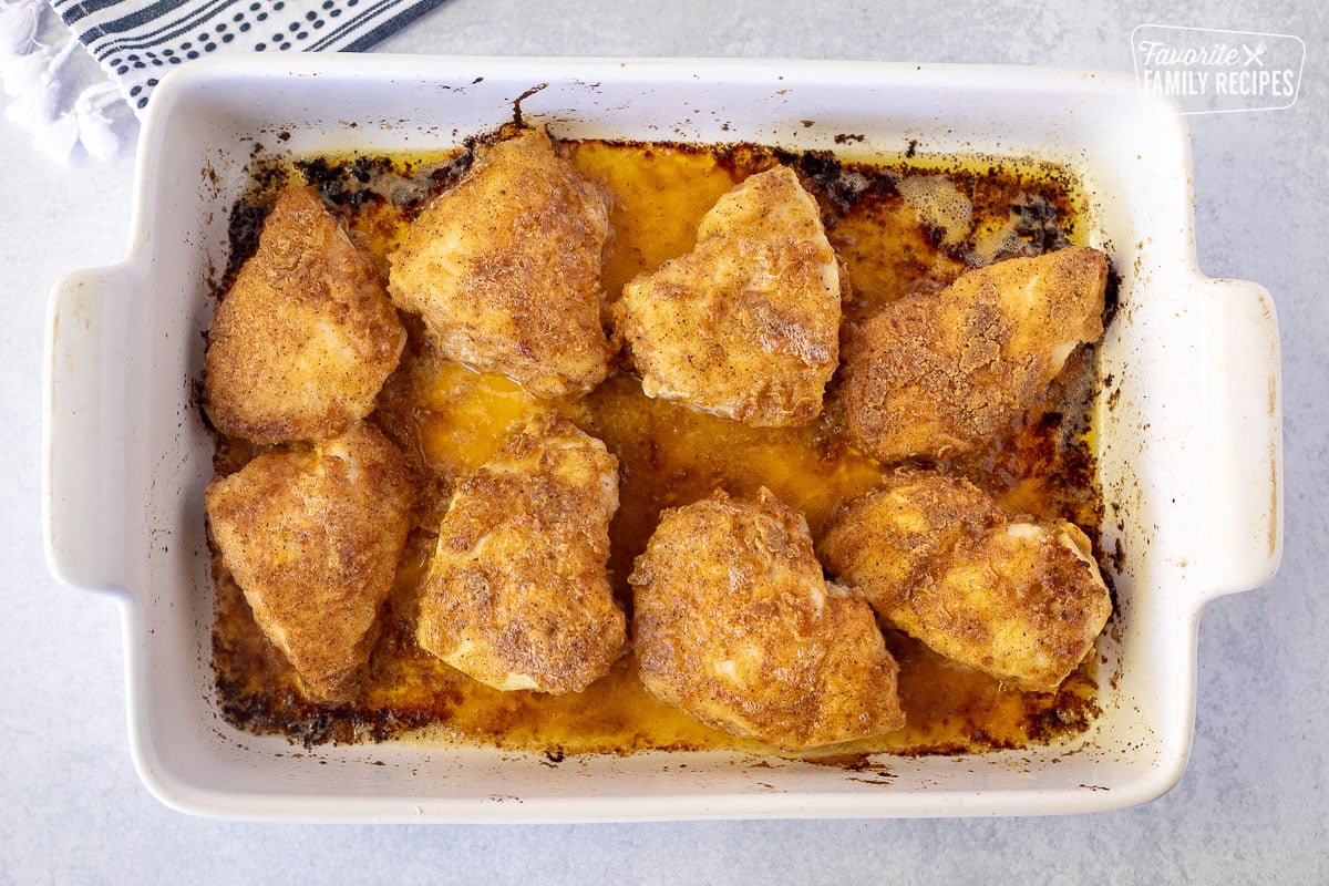Baked pieces of Oven Fried Chicken in a baking dish.