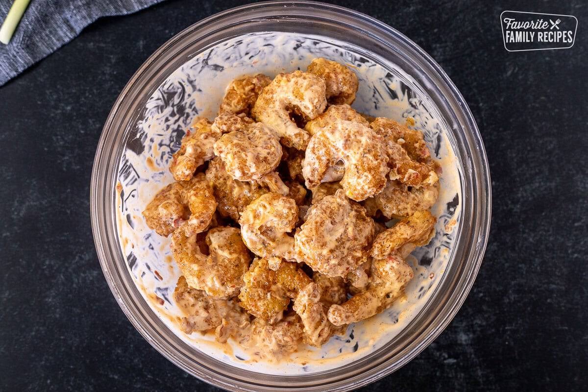 Mixed Bonefish Grill's Bang Bang Shrimp in a mixing bowl.