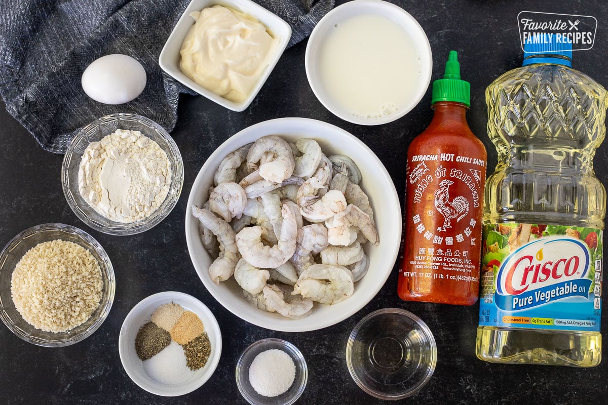 Ingredients to make Bonefish Grill's Bang Bang Shrimp including shrimp, panko, flour, rice vinegar, sugar, spices, milk, mayo, egg, sriracha and oil.
