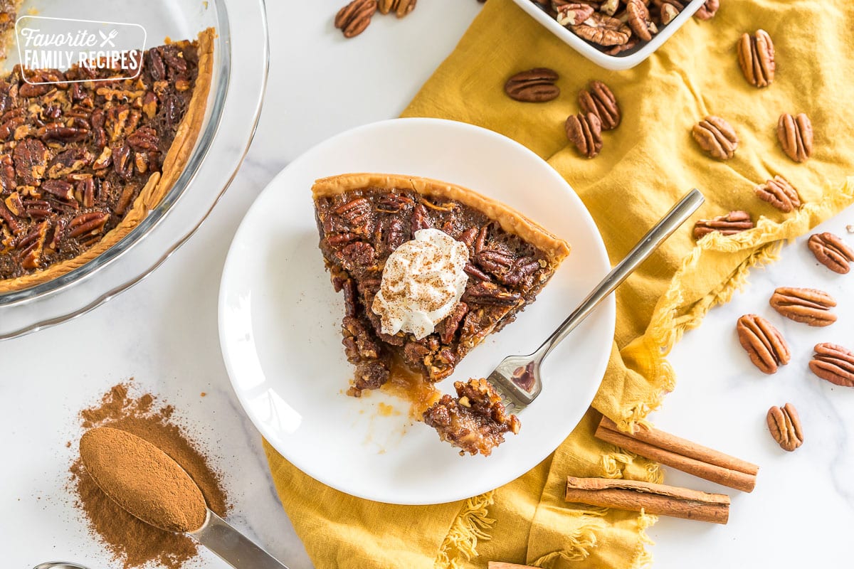 Brown Butter Pecan Pie on a plate topped with whipped cream