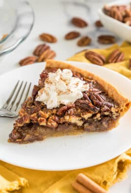 Brown Butter Pecan Pie on a plate topped with whipped cream