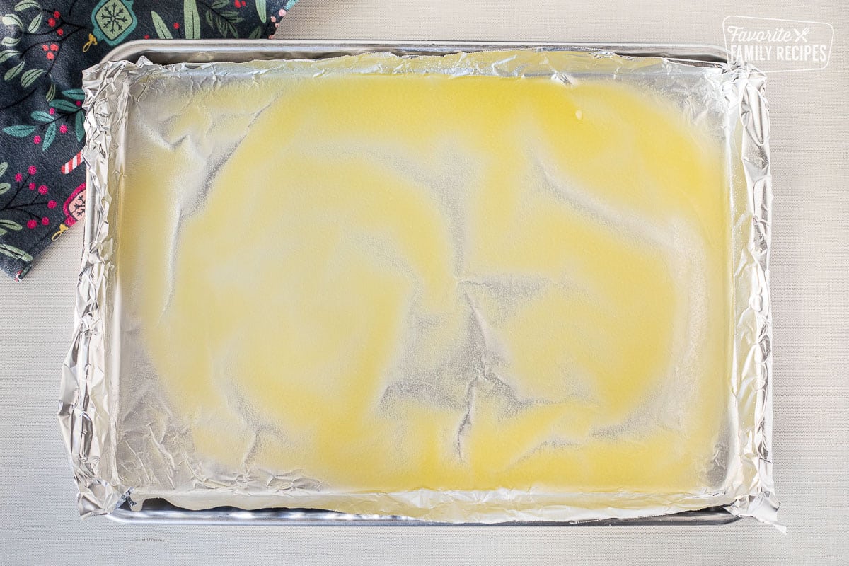 Melted butter on boil lined baking sheet.