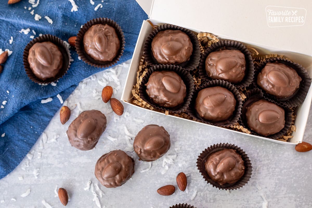 Candy box of Homemade Almond Joys next to other Almond Joys.