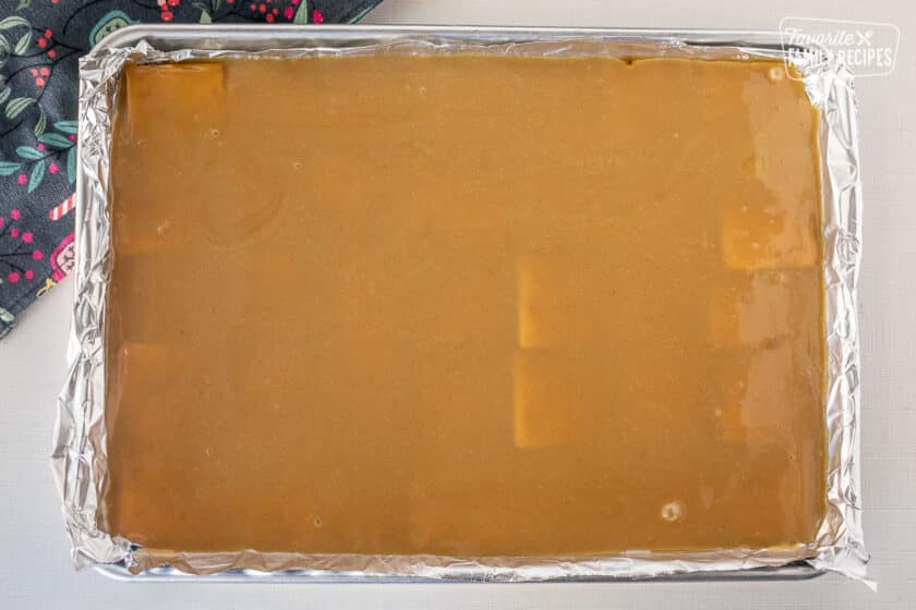 Carmel layer on top of saltine crackers in a foil lined baking sheet.
