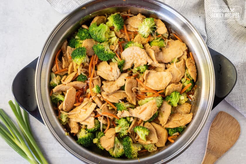 Skillet of cooked chicken and vegetables for Peanut Noodles.