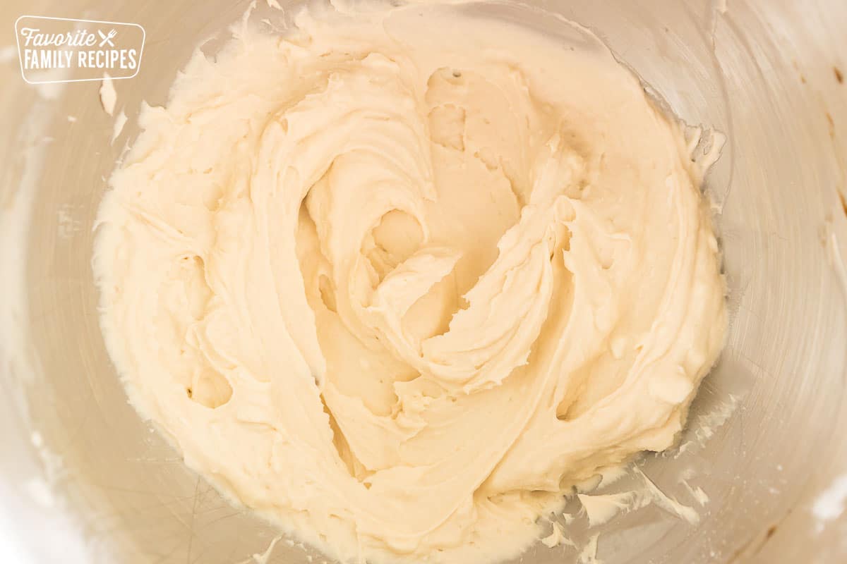 Sugar, butter, and cream cheese mixed in a bowl