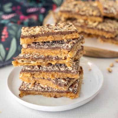 Stacked pieces of Saltine Cracker Toffee on a plate.