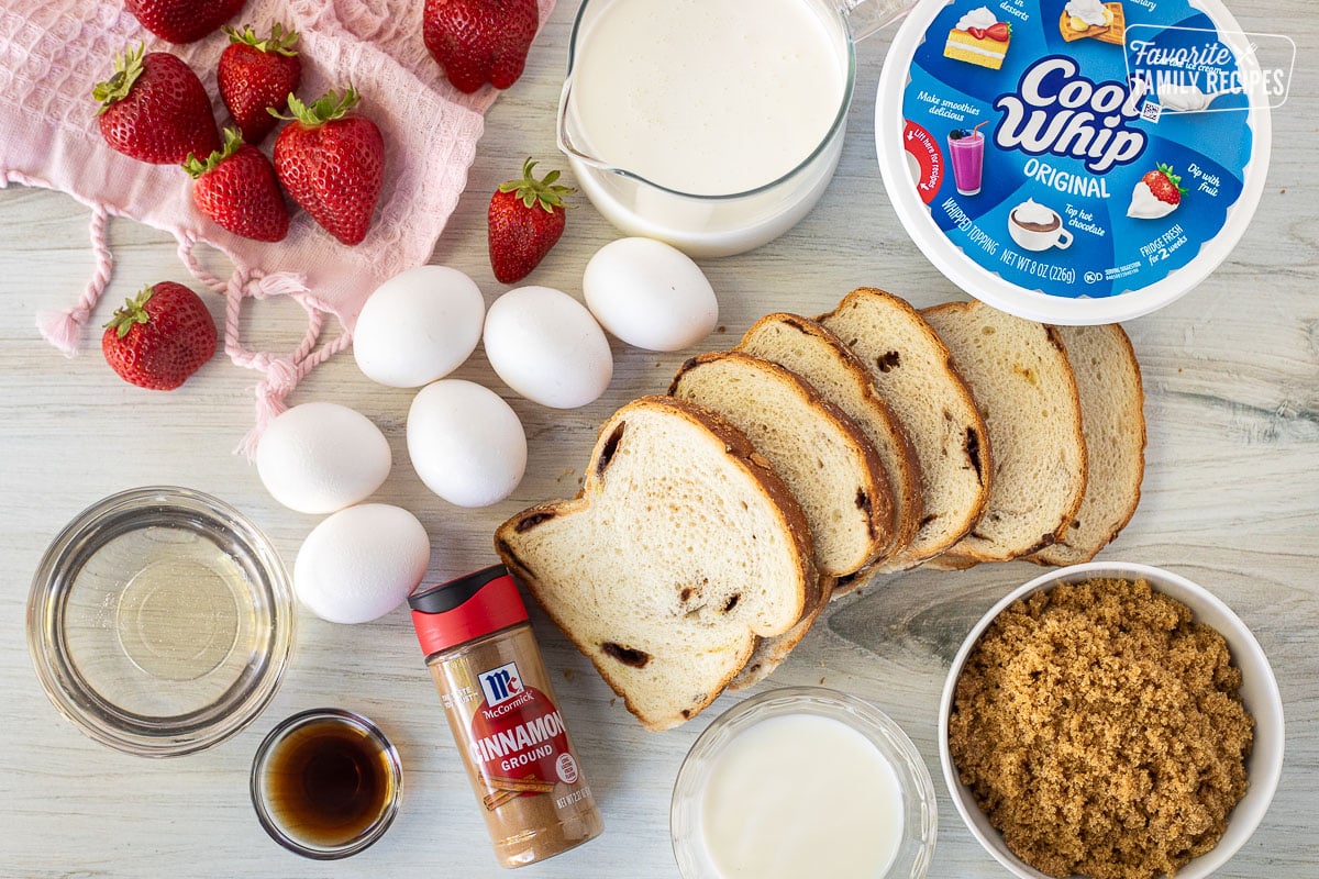 Ingredients to make Cinnamon French Toast including cinnamon bread, brown sugar, cinnamon, vanilla, corn syrup, eggs, milk, strawberries and Cool Whip.
