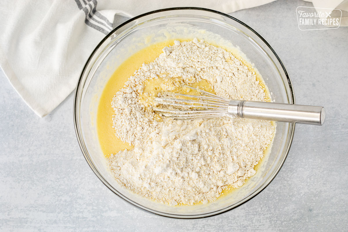 Bowl of Cornbread batter mixing with a whisk.
