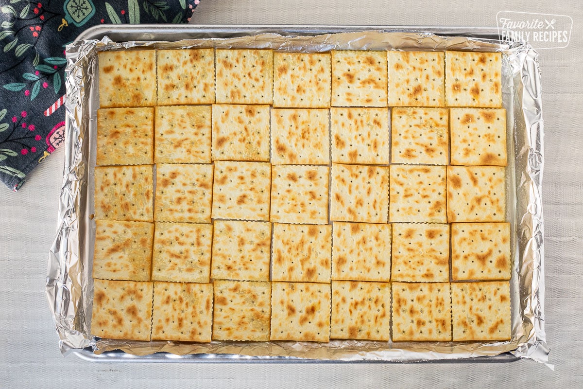Saltine cracker layer on top of butter in baking sheet.
