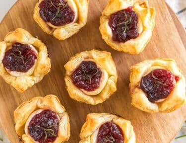 Cranberry Brie Bites on a wooden board