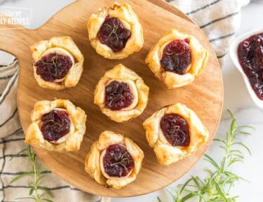 Cranberry Brie Bites on a wooden board