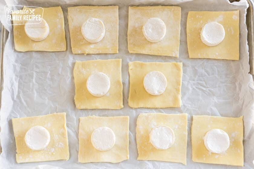 squares of puff pastry with cheese in the middle