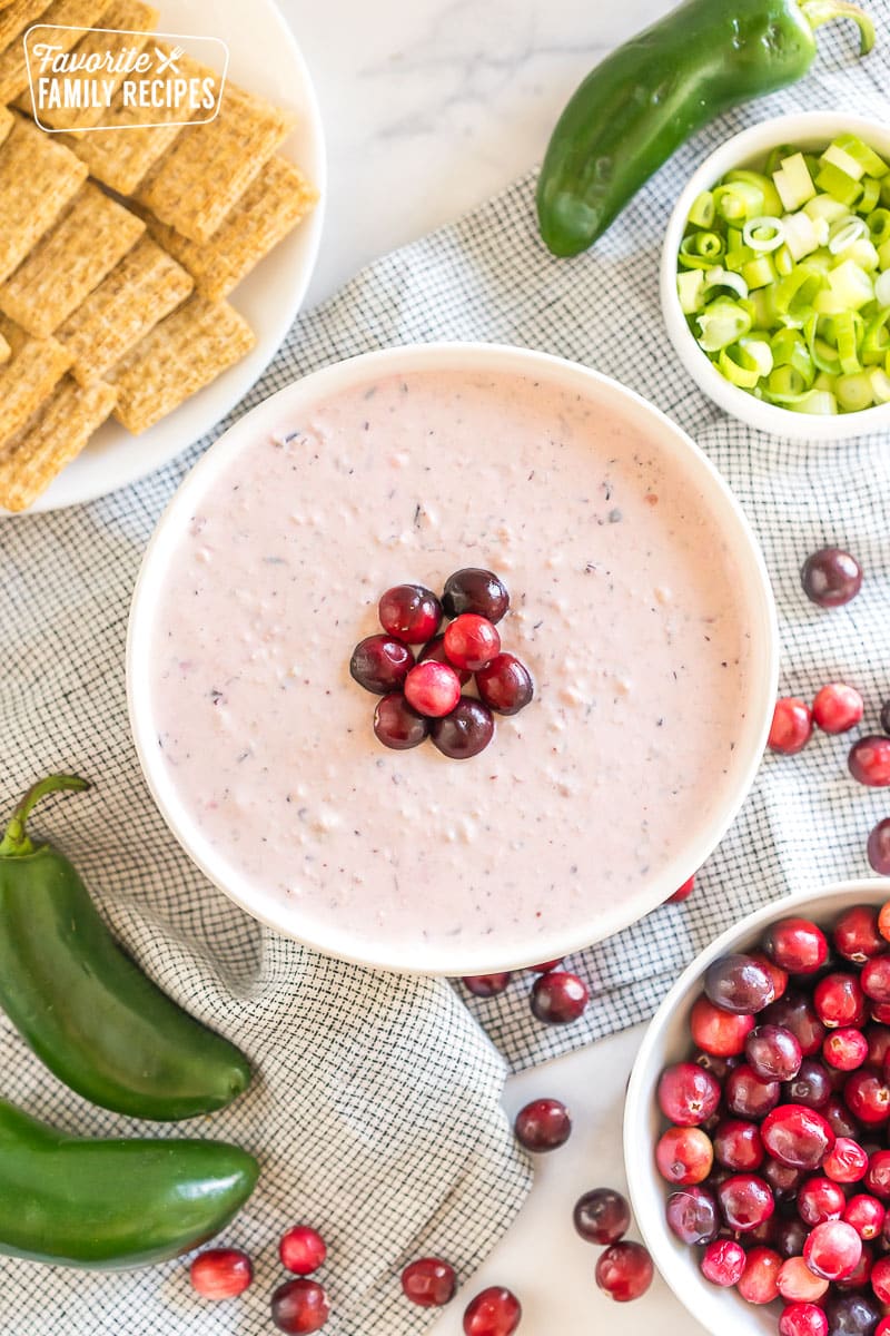 a bowl of cranberry jalapeno dip topped with cranberries