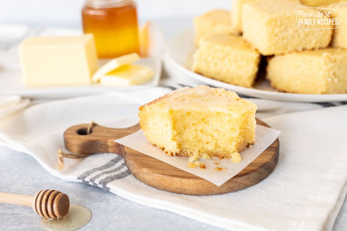 This Easy Cornbread Recipe is the perfect quick and easy side dish. It pairs perfectly with soups, chili or as a snack. Absolutely ideal for busy weeknight suppers! Cut corner of a Cornbread slice.