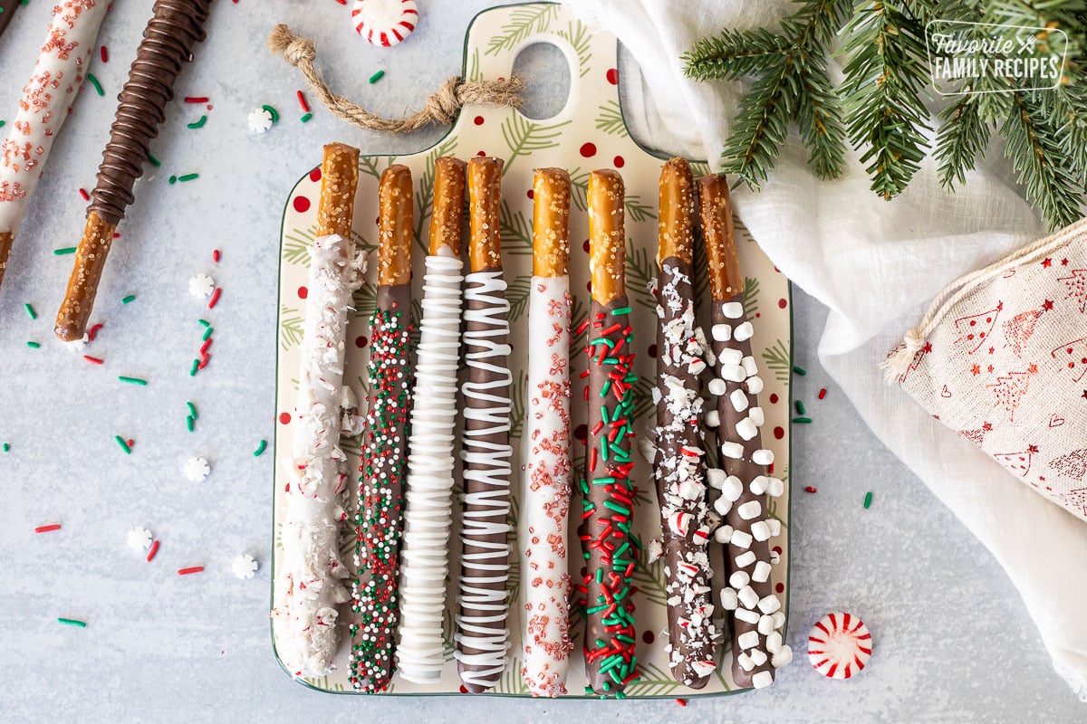 Christmas decorated Dipped Pretzel rods with sprinkles, crushed candy canes and marshmallow bits.