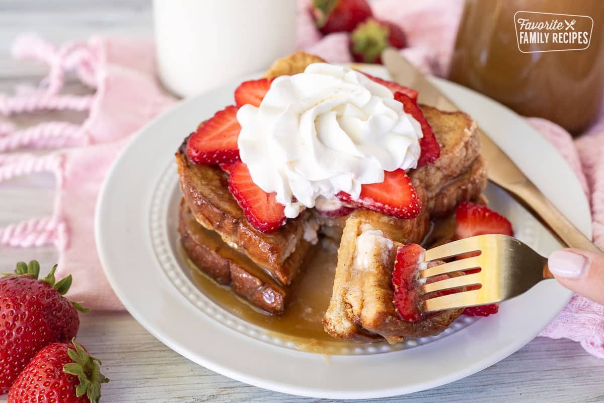 Fork cutting into Cinnamon French Toast.
