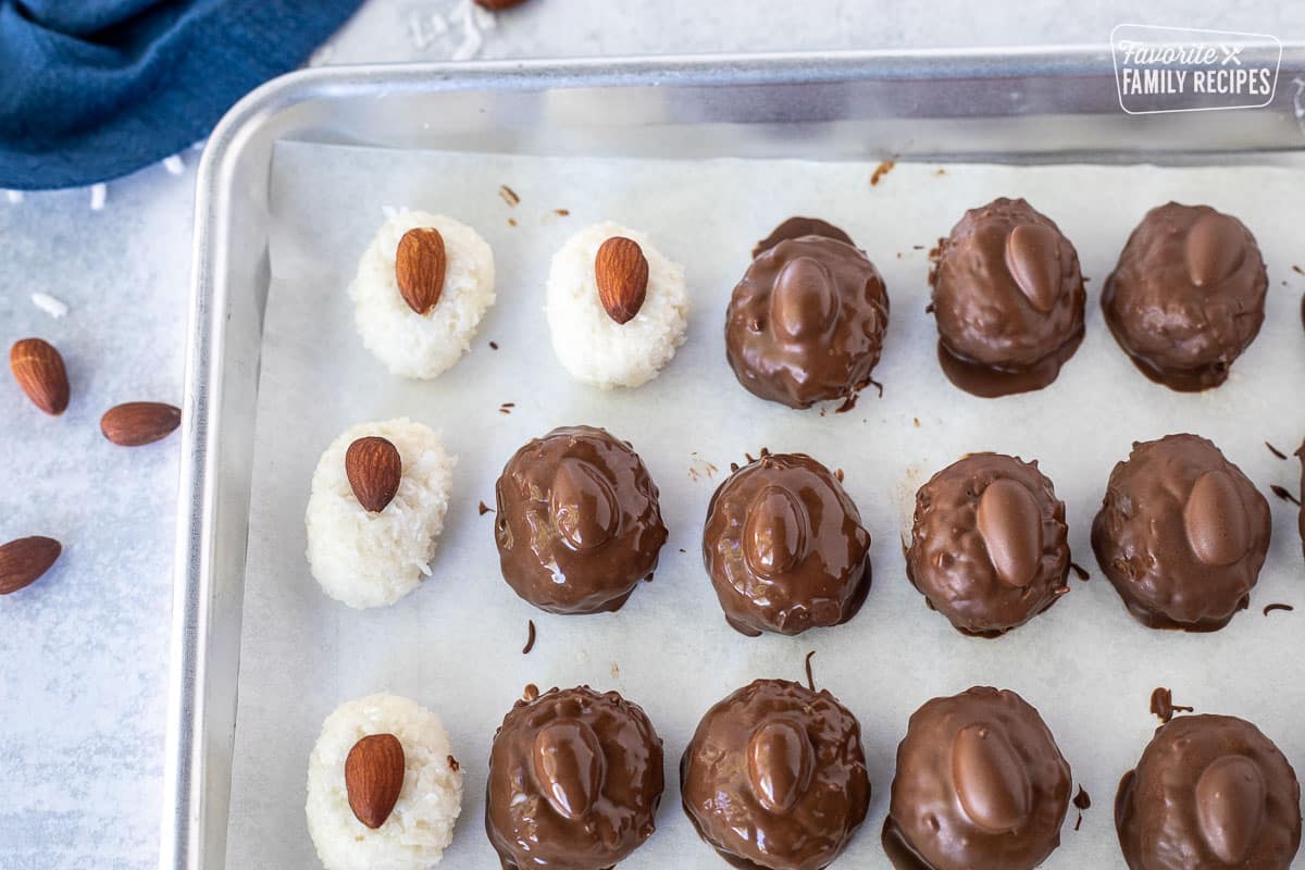 Sheet pan with some dipped and some not dipped Almond Joys.