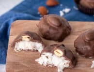 Cut open Homemade Almond Joy on a cutting board.