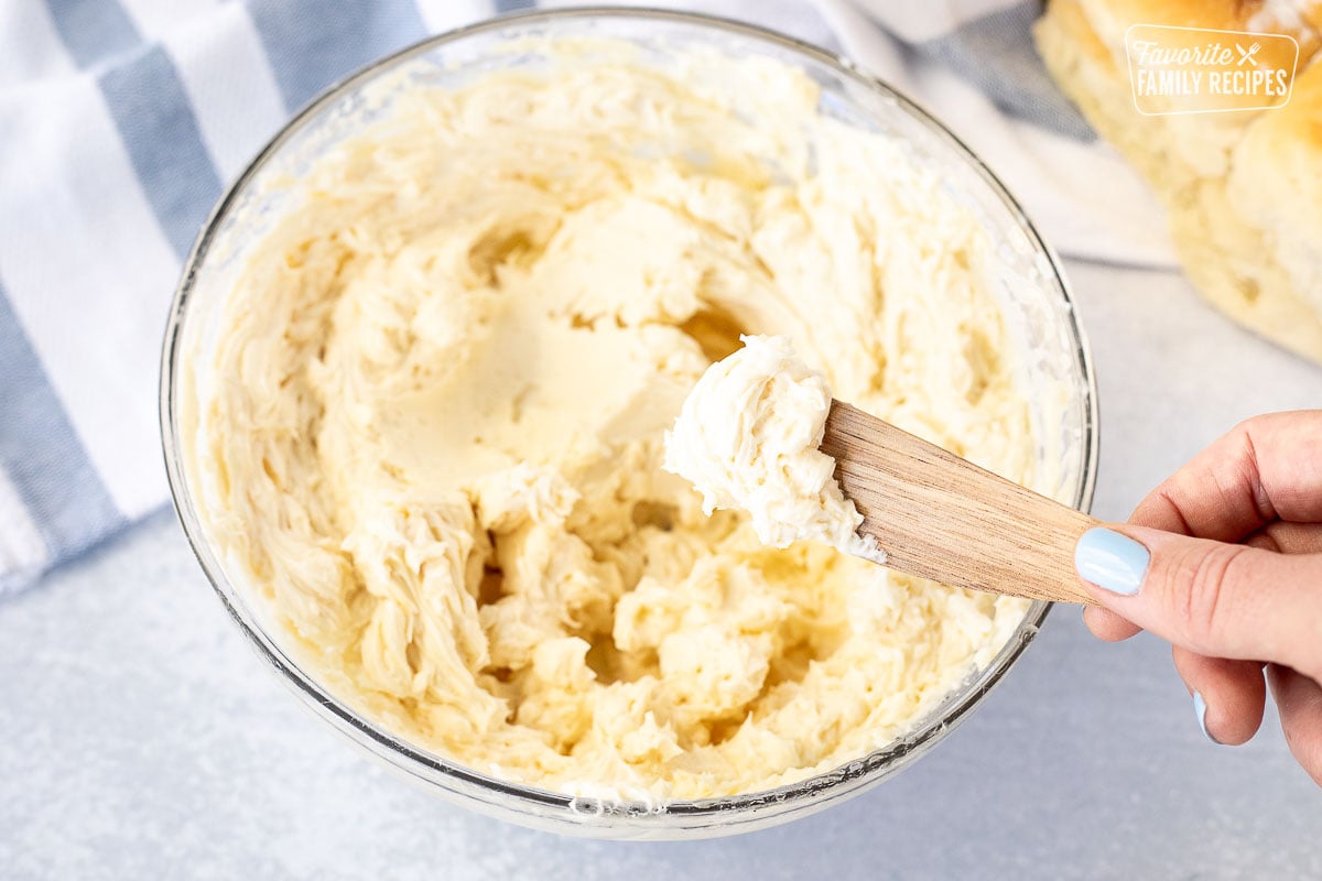 Mixing bowl with Homemade Honey Butter and wooden knife.