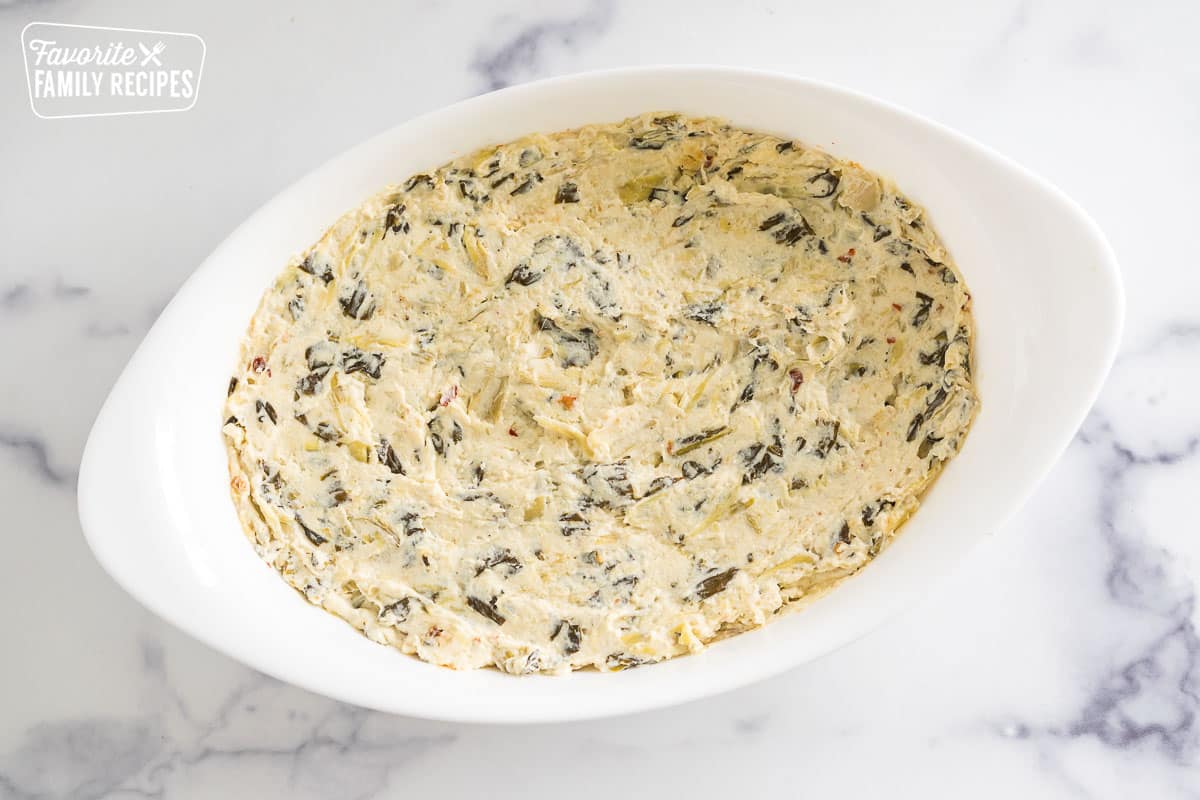 spinach artichoke dip in an oval baking dish