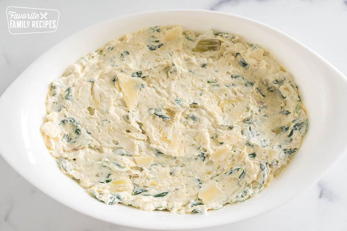 spinach artichoke dip in an oval baking dish