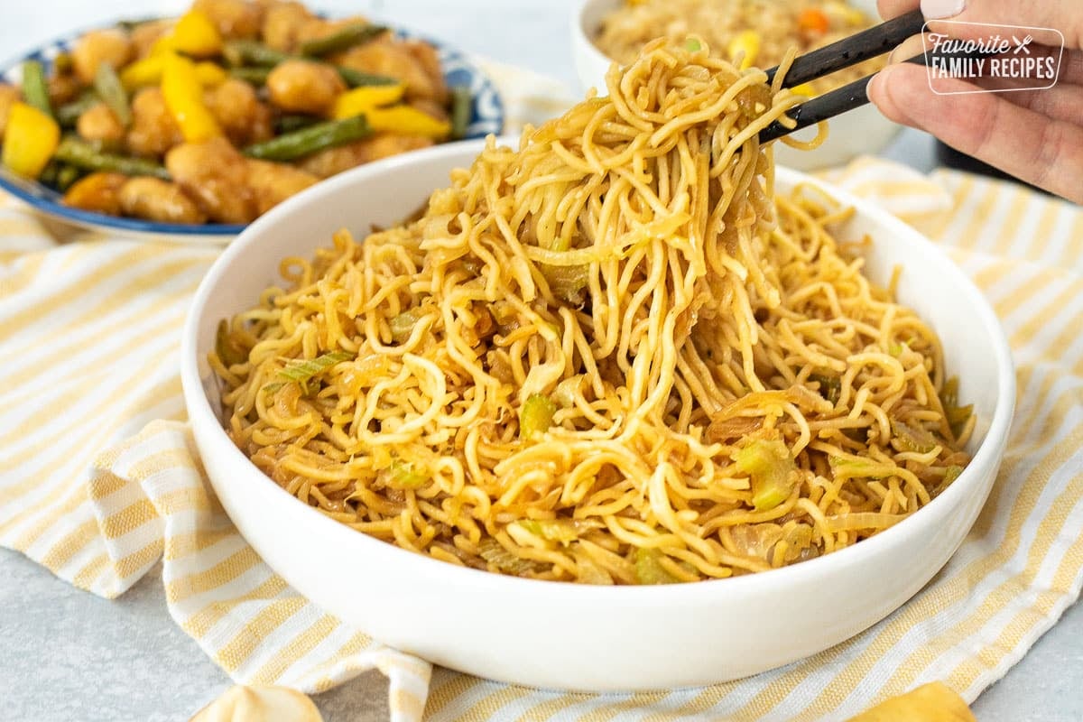 Chop sticks lifting a serving of Panda Express Chow Mein Noodles from the bowl.