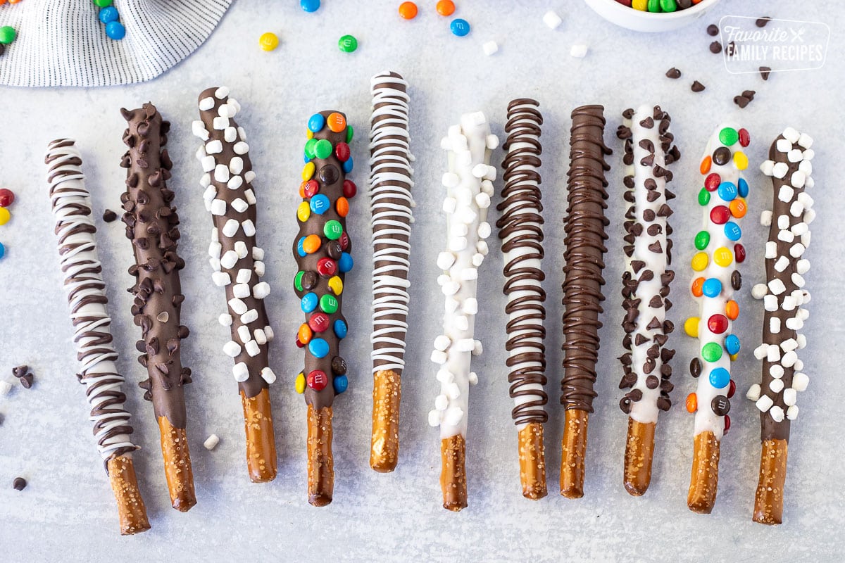 Dipped pretzel Rods decorated with mini chocolate chips, mini mnm's, chocolate swirls and marshmallow bits.