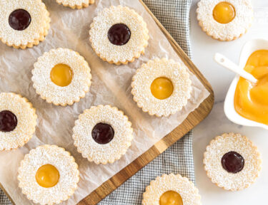 Linzer cookies on a cutting board