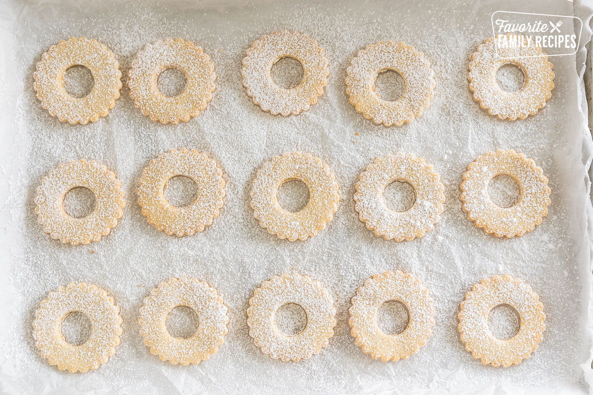 baked shortbread cookies on a baking sheet sprinkled with powdered sugar