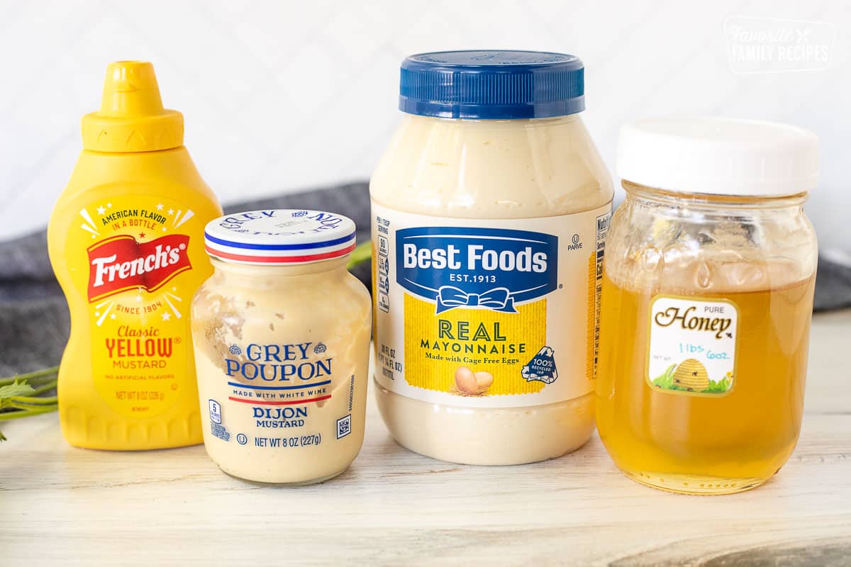 Ingredients to make Malibu Chicken Sauce including mayonnaise, honey, grey poupon and yellow mustard.