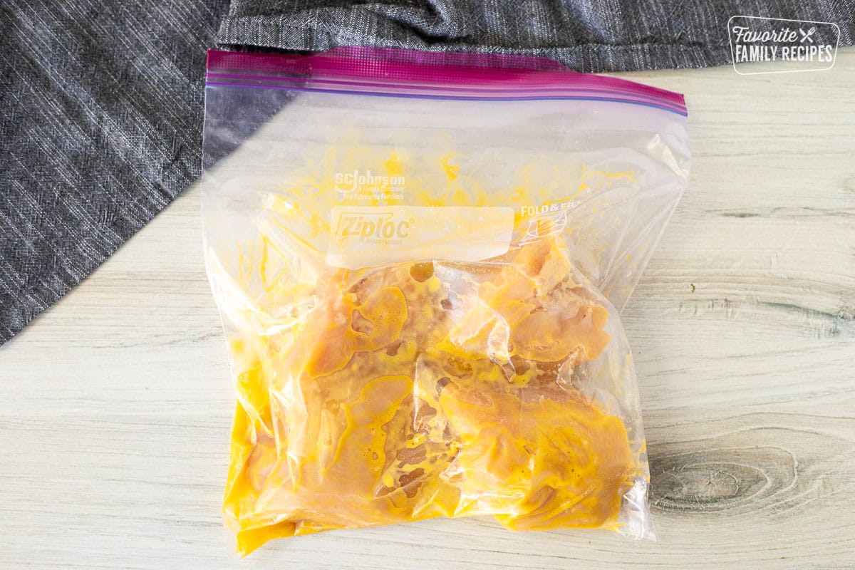 Ziplock bag with chicken breasts, yolks and garlic.