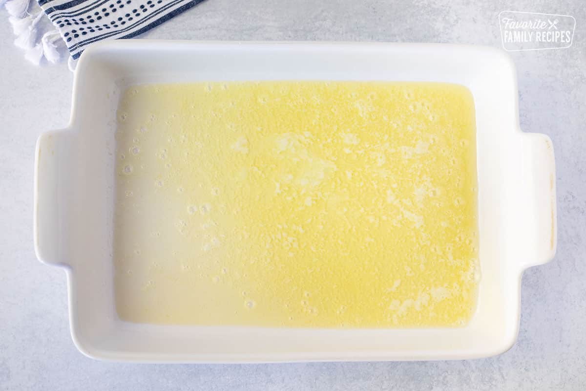 Casserole dish with melted butter.