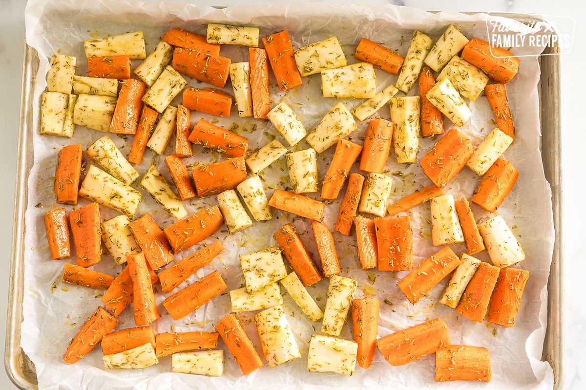 seasoned carrots and parsnips on a baking sheet