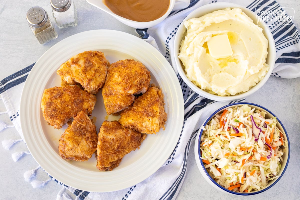 Plate of six pieces of Oven Fried Chicken. Mashed potatoes, gravy and Cole slaw on the side.