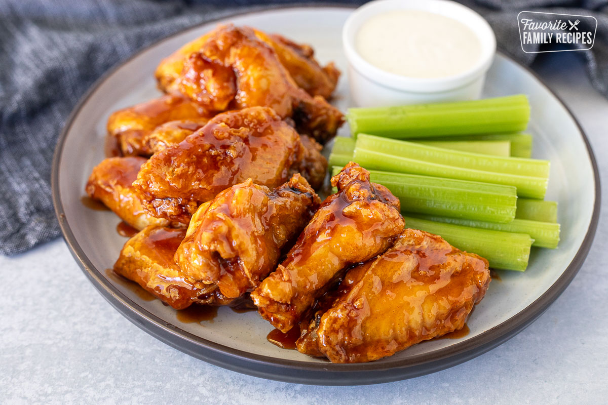 Plate of Winger's Wings with Freakin Amazing Sauce with celery sticks and ranch dressing.